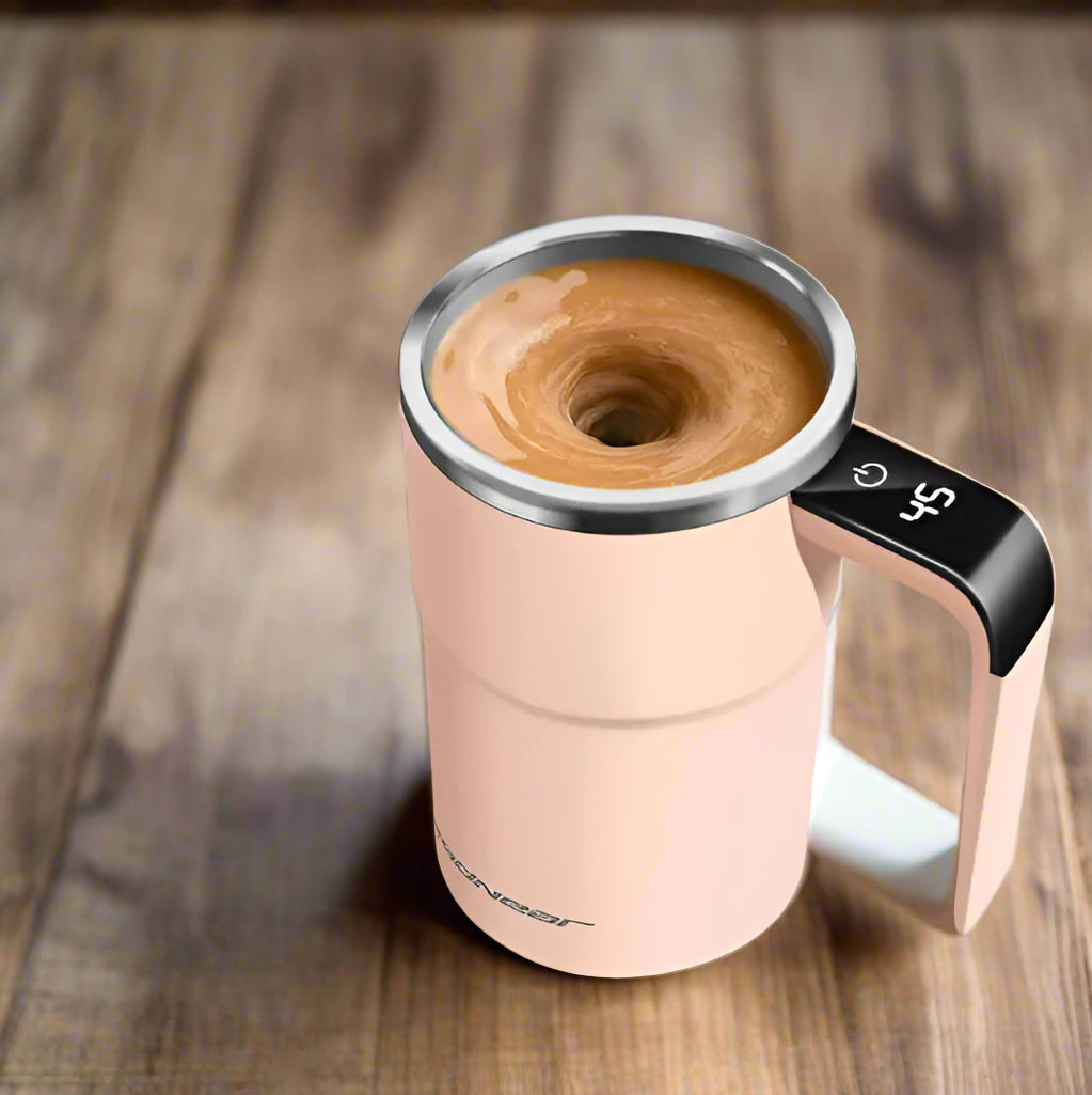 Pink travel mug with coffee and coffee beans on a magazine